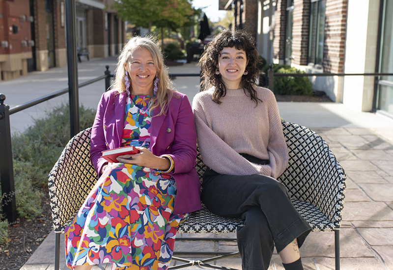 jolinda-jenna-outside-shapes-colors-graphic-web-design Jolinda Anderson and Jenna Marbukh sitting outside Gather Midlothian